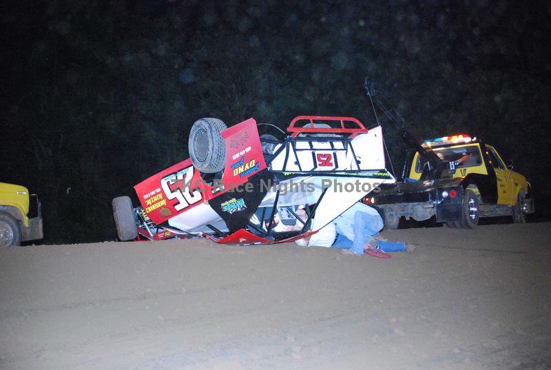 Oklahom Sports Park Safety crew is helping Modified Driver Brian Brandon out of the car after it turns over on it's head. 